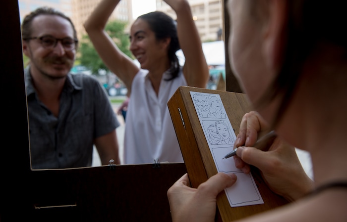 (Leah Hogsten | The Salt Lake Tribune) Charlie Zuckerman and girlfriend Nichole Anderson get their caricature drawn by artist Natalie Allsup-Edwards at the 9th Annual Craft Lake City DIY Festival, Friday, August 11, 2017. The festival runs through Sunday, August 13th at the Gallivan Center.
