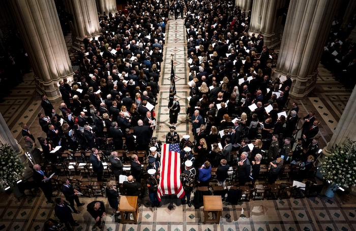 The flag-draped casket of former President George H.W. Bush is carried out by a military honor guard during a State Funeral at the National Cathedral, Wednesday, Dec. 5, 2018, in Washington. (Doug Mills/The New York Times via AP, Pool)