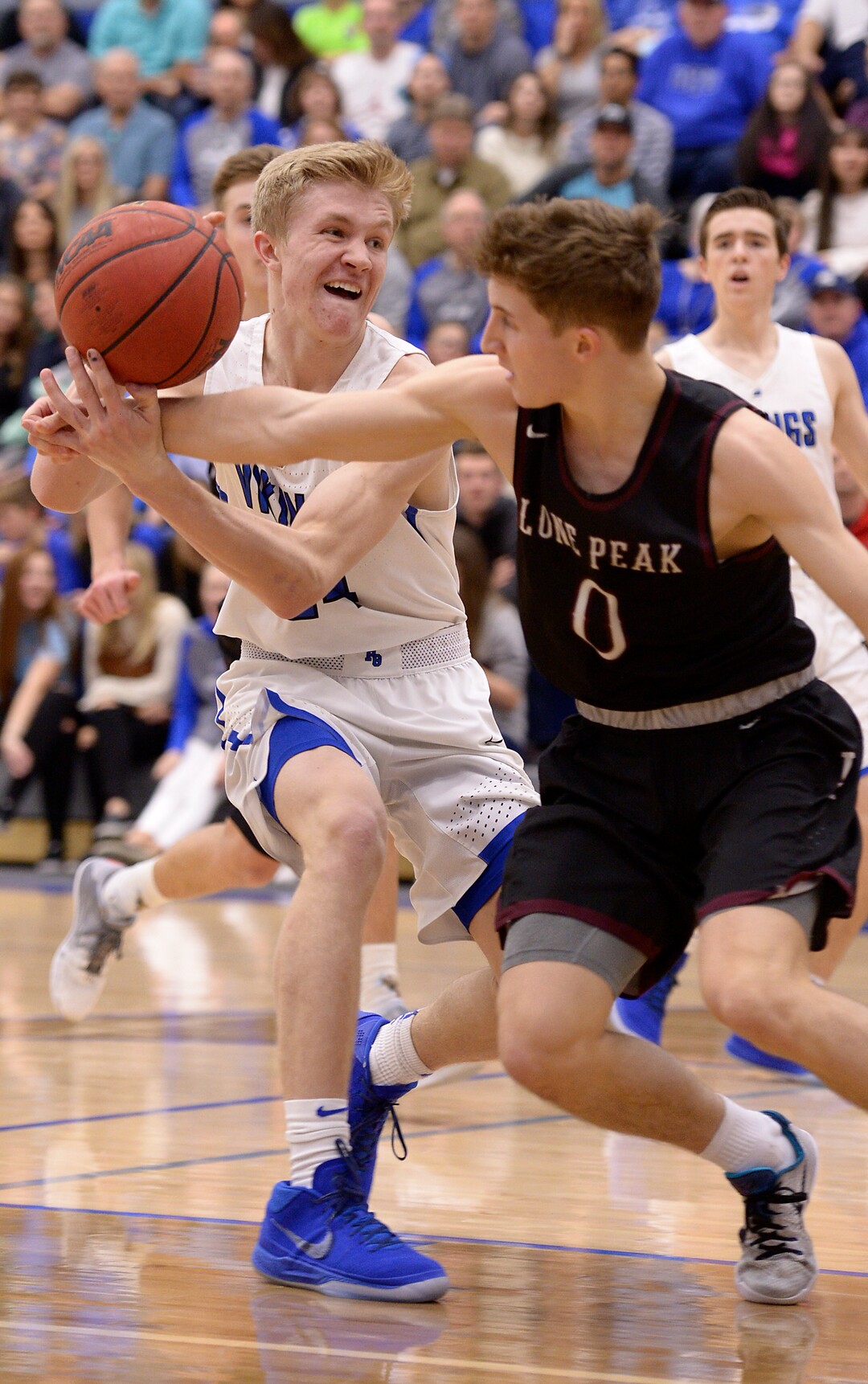 (Leah Hogsten  |  The Salt Lake Tribune) Pleasant Grove's Kael Mikkelsen is fouled by Lone Peak's Chantry Ross. Lone Peak High School boys' basketball team defeated Pleasant Grove High School 65-61 during their game Friday, January 26, 2018 in Pleasant Grove. 
