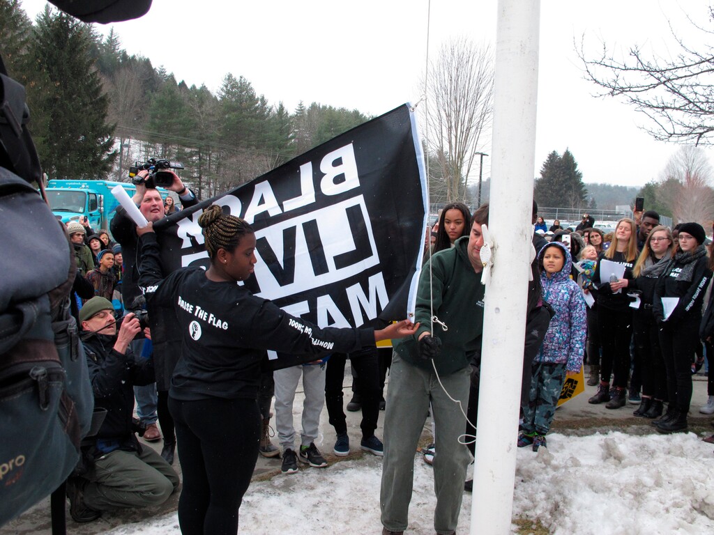 Students at the Montpelier High School in Montpelier, Vt., raise a Black Lives Matter flag on Thursday, Feb. 1, 2018, as part of a series of activities to discuss racism. The student-led move, part of Black History Month, in the Montpelier school that is less than 5 percent black has sparked some backlash, but school officials say they've received overwhelming support from the community. (AP Photo/Lisa Rathke)