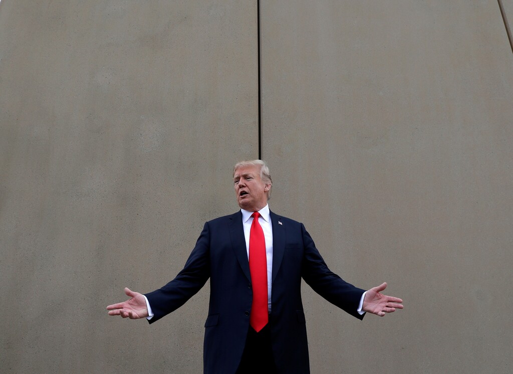 FILE - In this March 13, 2018, file photo, President Donald Trump speaks during a tour as he reviews border wall prototypes in San Diego. Trump said Sunday, July 29, 2018, that he would consider shutting down the government if Democrats refuse to vote for his immigration proposals, including building a wall along the U.S.-Mexico border.  (AP Photo/Evan Vucci, File)