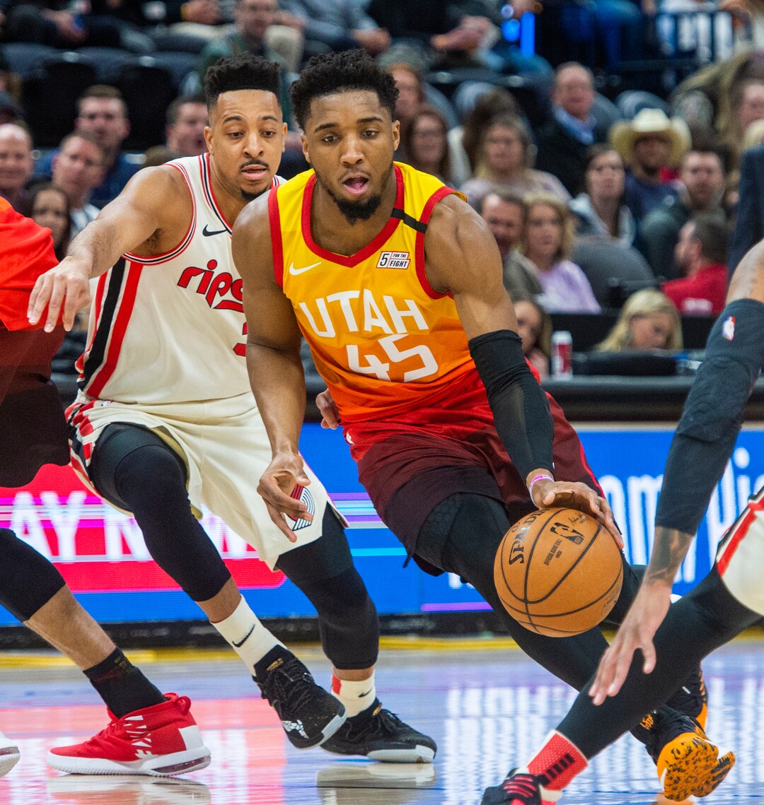 (Rick Egan  |  The Salt Lake Tribune)     Utah Jazz guard Donovan Mitchell (45) takes the ball up the middle, as Portland Trail Blazers guard CJ McCollum (3) defends, in NBA action between the Utah Jazz and thePortland Trail Blazers in Salt Lake City, Friday, Feb. 7, 2020.