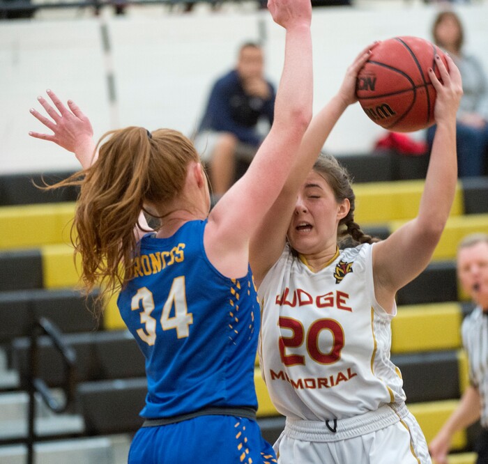 (Rick Egan  |  The Salt Lake Tribune)    San Juan forward, Delaney Palmer, (34) defends as Abbey Storms (20), Judge Memorial takes the ball up the middle, in 3A Women's basketball playoff action Judge Memorial Vs. San Juan, in Heber City, Friday, Feb. 16, 2018.
