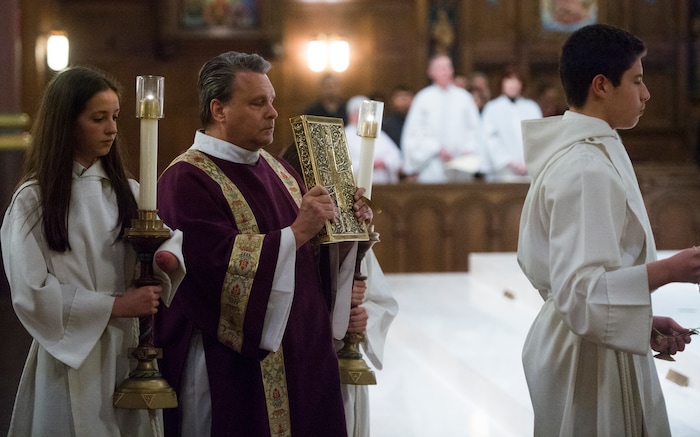 (Rick Egan | The Salt Lake Tribune) The Deacon John Kranz (center) during the Ash Wednesday Mass, at the Cathedral of The Madeleine, Wednesday, Feb. 14, 2018.