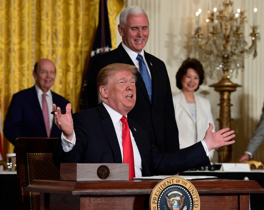 President Donald Trump gestures as he signs a "Space Policy Directive" during a meeting of the National Space Council in the East Room of the White House, Monday, June 18, 2018, in Washington, as Vice President Mike Pence watches.  AP Photo/Susan Walsh)