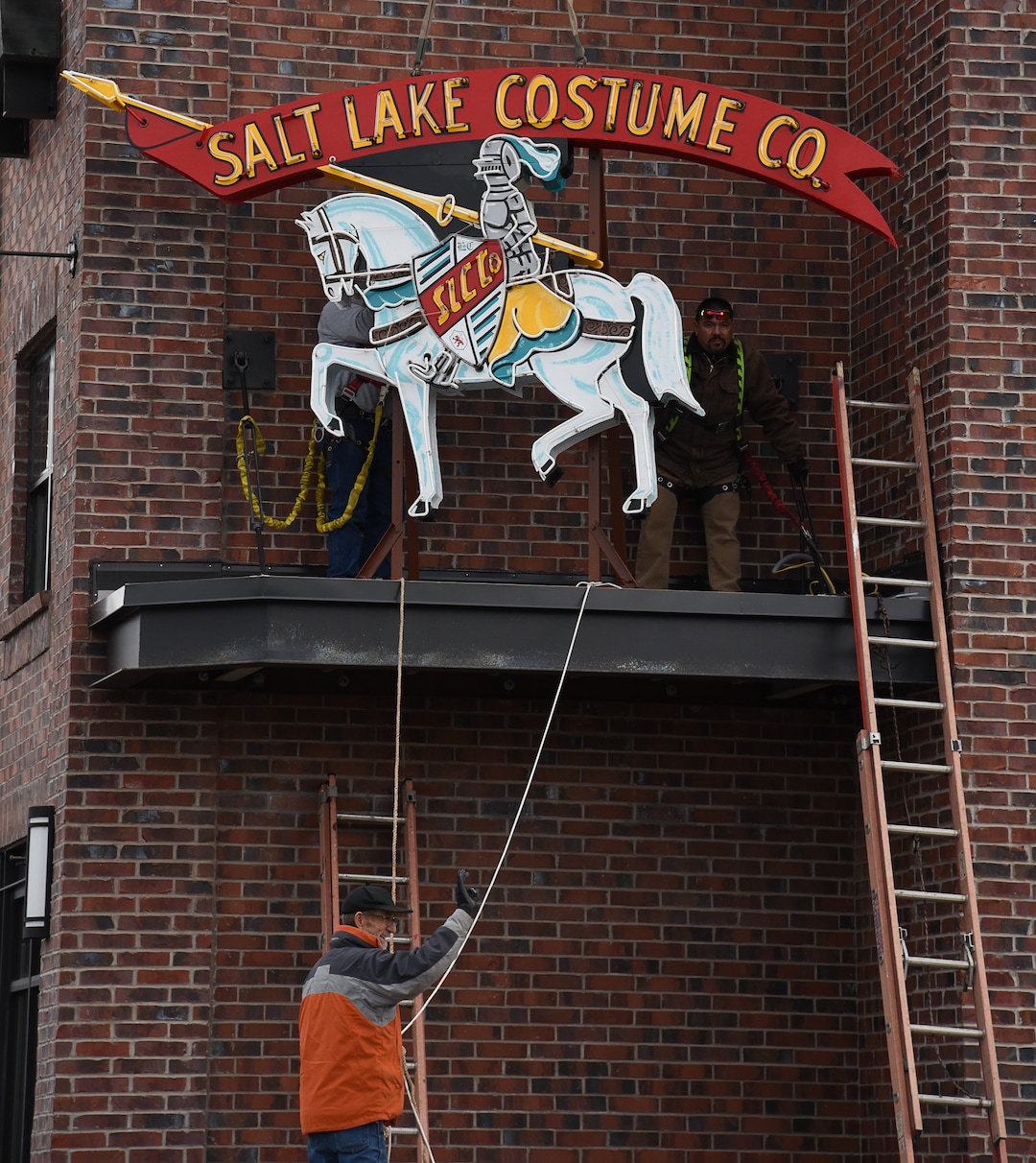 (Francisco Kjolseth  |  The Salt Lake Tribune)  The Salt Lake Costume Co. sign, originally designed by Lloyd S. Coley in the '50s while working for Rainbow Neon Sign Co., lives on once more as it is installed back home in its original location at 1700 S. 1100 East on Monday, Dec. 23, 2019, in what is now called the Salt Lake Costume Apartments.