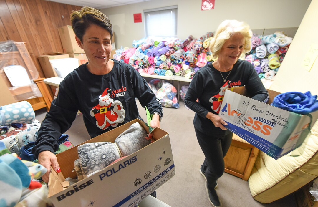 (Francisco Kjolseth  |  The Salt Lake Tribune)  Jen Wunderli, left, and Ann Jensen assemble Christmas care packages for those in need as part of the Granite Education Foundation's Santa Sacks program created in 2009. Working with social workers who know each of the students individually in the lowest of income families across 60 schools in the Granite district, volunteers expect to fill over 3000 sacks.