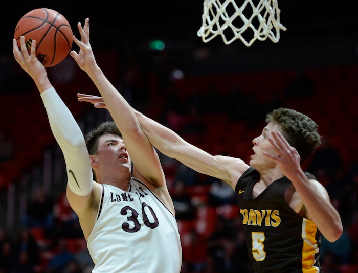 (Francisco Kjolseth  |  The Salt Lake Tribune)  Davis vs Lone Peak, 6A State high school basketball tournament at the Huntsman Center in Salt Lake City, Thursday March 1, 2018. Jackson Brinkerhoff (3) goes up against Josh Sanders (5). 