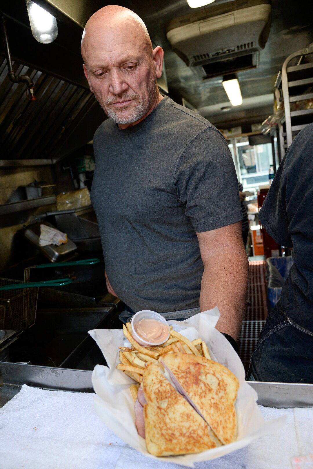 (Francisco Kjolseth  |  The Salt Lake Tribune)  Allen Johnson shows off one of his signature grilled cheese sandwiches during Trolley Square Food Truck Night on Wednesday, July 17, 2019. Three of the vendors for the night, along with four others, will vie for the title of Best New Food Truck on Aug. 3 at the Food Truck and Brewery Battle at The Gateway.