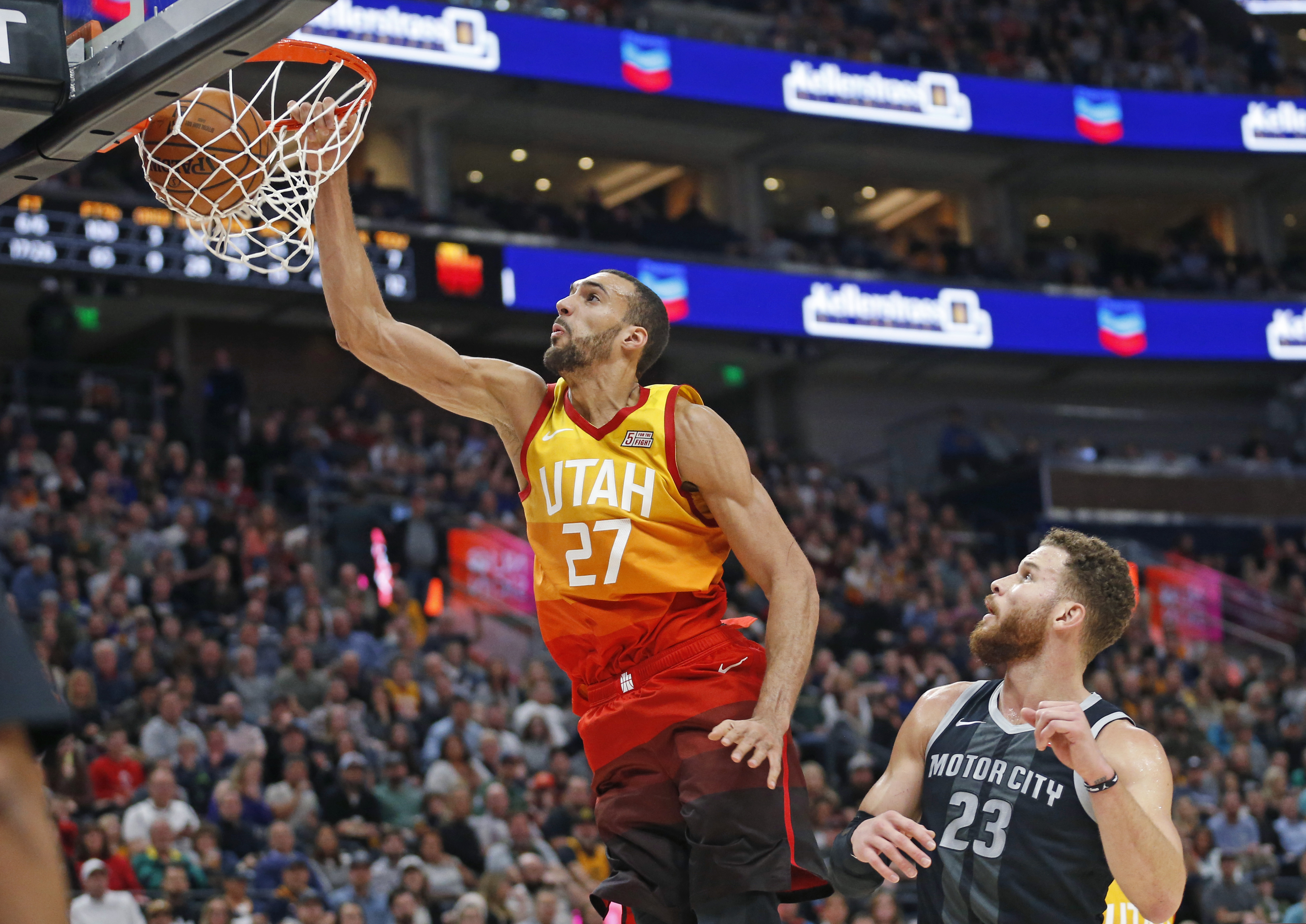Utah Jazz center Rudy Gobert (27) dunks the ball as Detroit Pistons forward Blake Griffin (23) looks on during the second half of an NBA basketball game Monday, Jan. 14, 2019, in Salt Lake City. (AP Photo/Rick Bowmer)