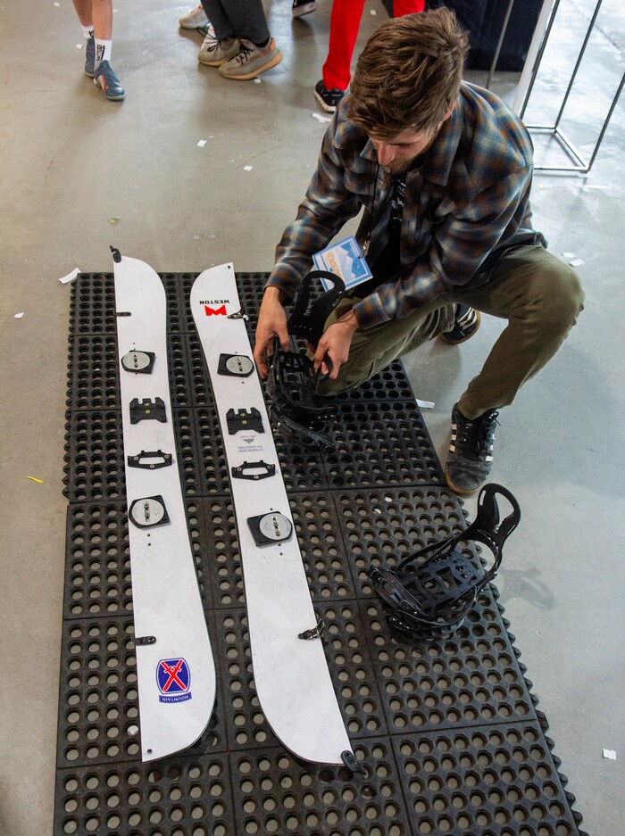 (Rick Egan | The Salt Lake Tribune)
Ben Smith puts together a splitboard, which converts two skis in to a snowboard for the back country, at the Weston booth, at the “Rendezvous” Mountain Culture Festival at the Gateway, Saturday, Sept. 28, 2019.