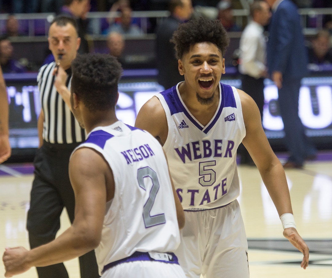(Rick Egan  |  The Salt Lake Tribune)       Weber State guard Ricky Nelson (2) and guard Cody John (5) celebrate The Wildcat's win over BYU, in basketball action between Brigham Young Cougars and Weber State Wildcats, at the Dee Event Center in Ogden, Saturday, Dec. 1, 2018.