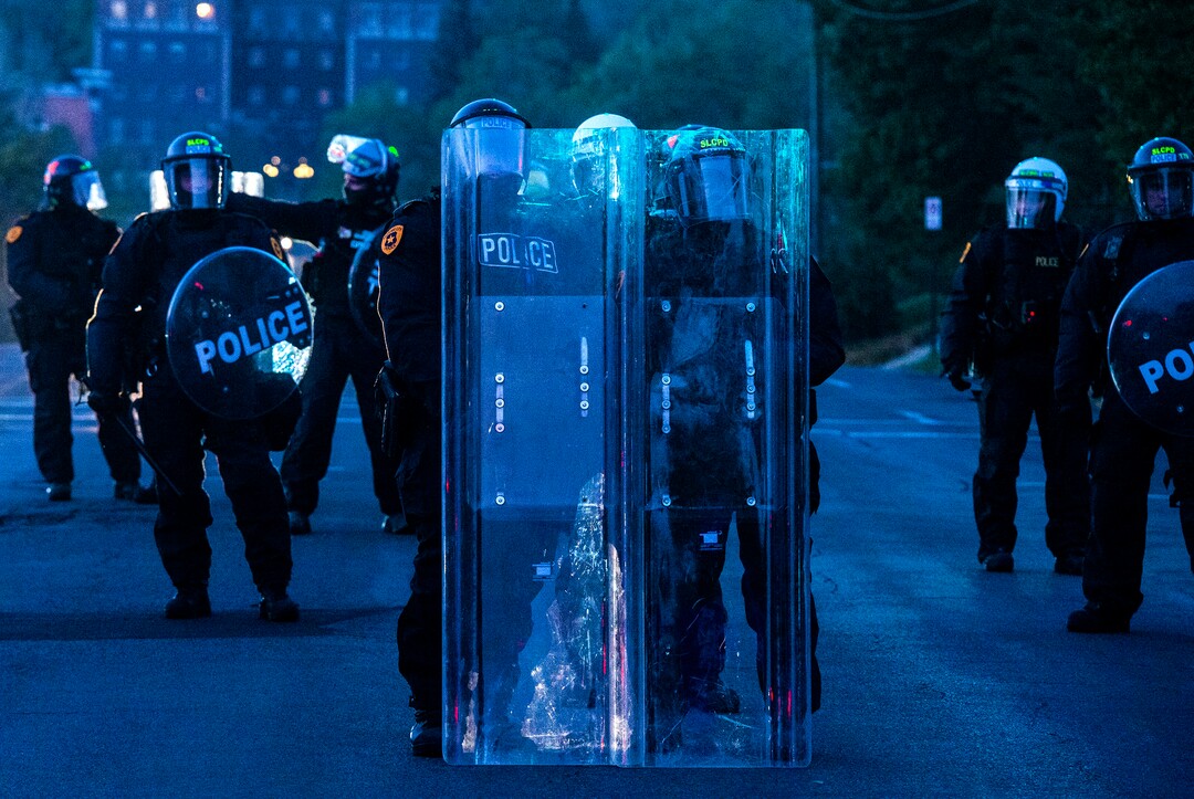 (Rick Egan  |  The Salt Lake Tribune) Protesters face a line of police in riot gear on 1300 East and 200 South, near the University of Utah where Mike Pence is debating Kamala Harris on Wednesday, Oct. 7, 2020.