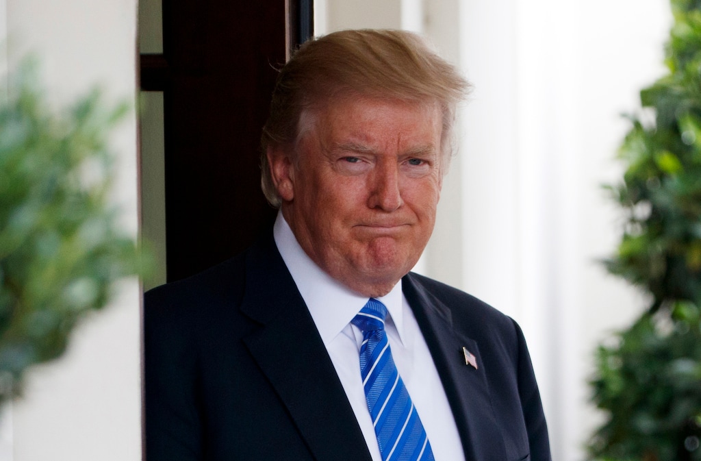 President Donald Trump waits outside the West Wing of the White House for the arrival of Malaysian Prime Minister Najib Razak, Tuesday, Sept. 12, 2017, in Washington. ESPN distanced itself from anchor Jemele Hill's tweets one day after she called Trump "a white supremacist" and "a bigot."  (AP Photo/Evan Vucci)