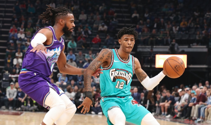 Memphis Grizzlies guard Ja Morant looks to pass as Utah Jazz guard Mike Conley (10) defends in the first half of an NBA basketball game Friday, Nov. 29, 2019, in Memphis, Tenn. (AP Photo/Karen Pulfer Focht)
