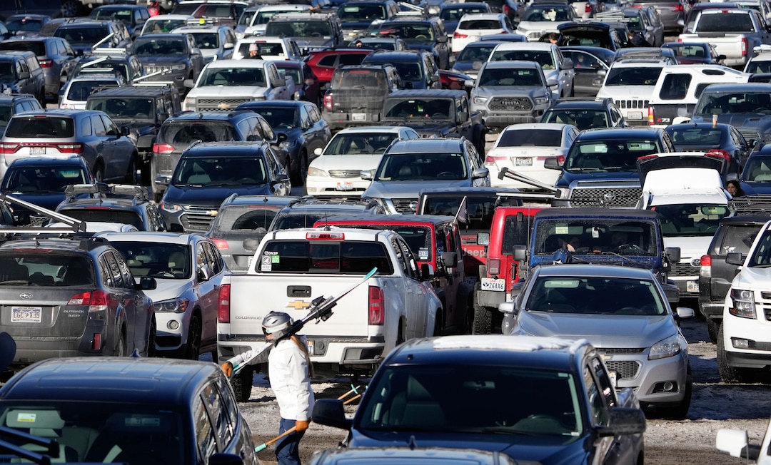 (Francisco Kjolseth | The Salt Lake Tribune) People navigate a full parking lot at Park City Mountain Resort as clear skies and some recent fresh snow draws the crowds on Saturday, Dec. 18, 2021.