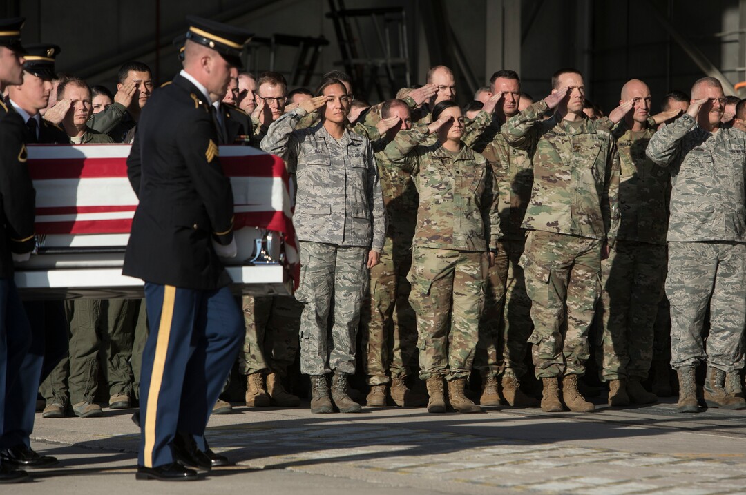 (Matt Herp  |  The Ogden Standrad Examiner/Pool) Members of the Utah National Guard salute as members of the Utah National Guard Honor Guard Detail carry a casket containing the remains of Maj. Brent R. Taylor at Roland R. Wright Air National Guard Base in Salt Lake City, Utah, on Wednesday, Nov. 14, 2018. Taylor, 39, of North Ogden, died Nov. 3, 2018, in Afghanistan of wounds sustained from small arms fire. His funeral is scheduled for Saturday, Nov. 17, in Ogden.
