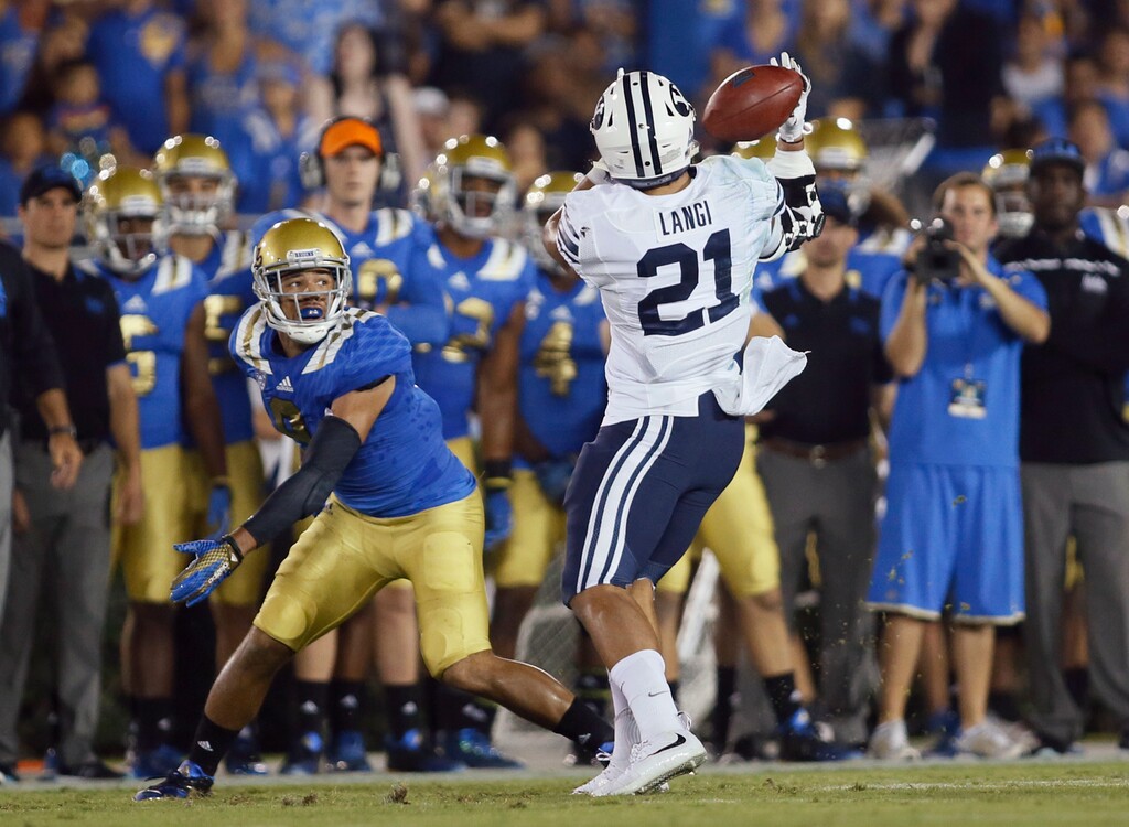 BYU linebacker Harvey Langi, right, intercepts a pass intended for UCLA wide receiver Jordan Payton during the first half of an NCAA college football game, Saturday, Sept. 19, 2015, in Pasadena, Calif. (AP Photo/Danny Moloshok)