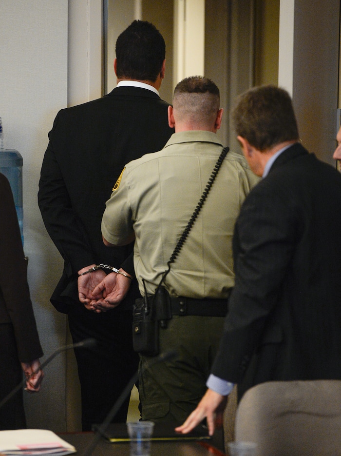 (Francisco Kjolseth  |  The Salt Lake Tribune)  Former Brighton High and University of Southern California linebacker Osa Masina, center, is taken into custody during his sentencing for sexual battery at the Matheson Courthouse in Salt Lake City on Tuesday, Dec. 5, 2017. Masina was sentenced to 365 days in jail, followed by two years on probation.