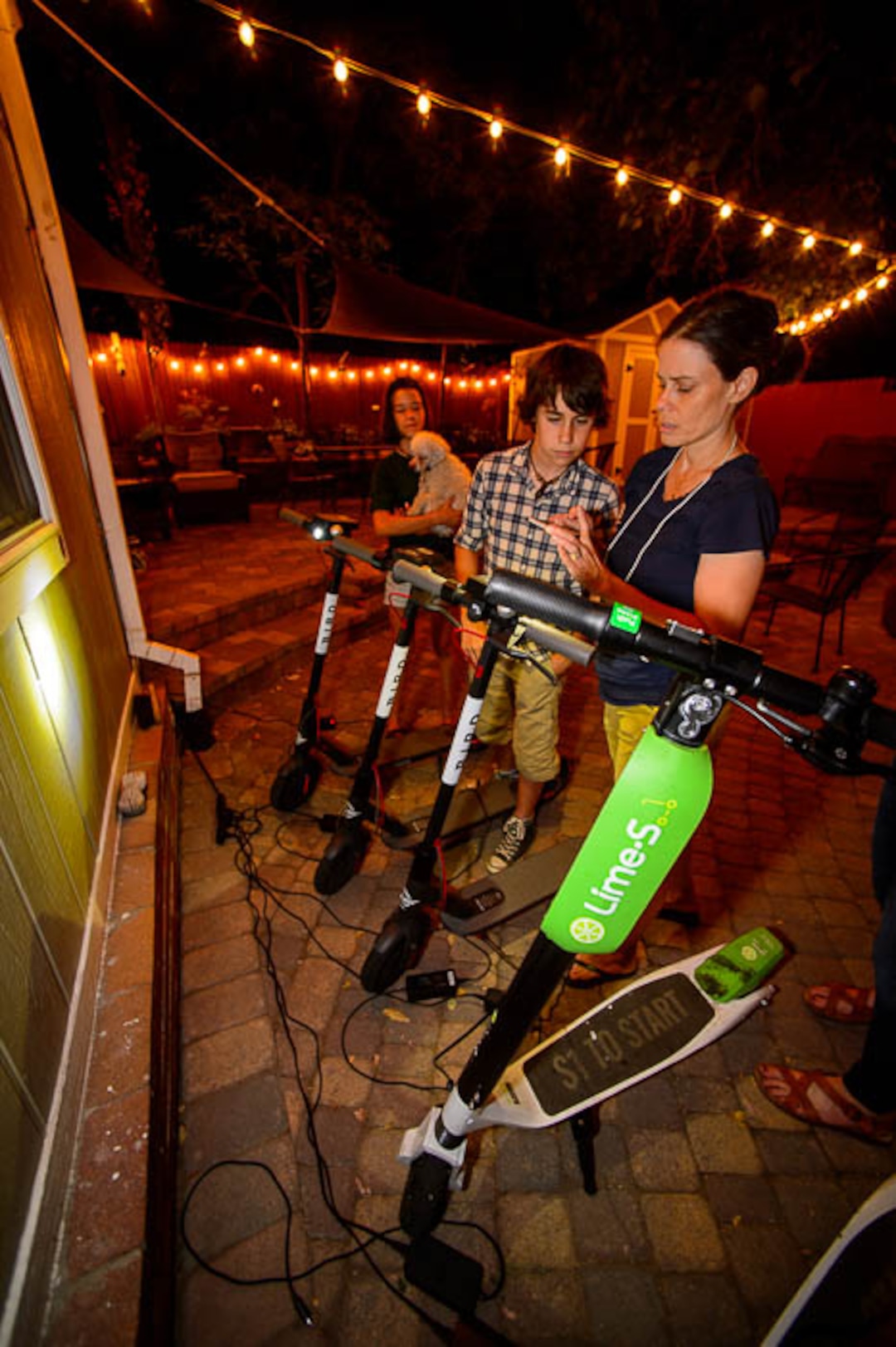 (Trent Nelson | The Salt Lake Tribune) Ady, Chase, and Jenn Hein charge scooters in Salt Lake City Tuesday Aug. 7, 2018. Jenn Hein works as a "Bird charger" on the side to make some extra cash, picking up and charging electric scooters overnight and returning them to the city streets in the early morning.