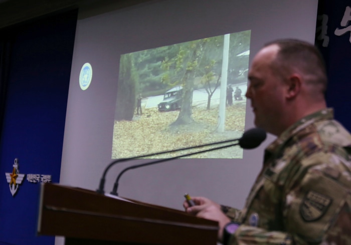 Col. Chad G. Carroll, a spokesman for the U.N. command, shows the CCTV footage regarding a North Korean soldier's defection during a press conference at the Defense Ministry in Seoul, South Korea, Wednesday, Nov. 22, 2017. A North Korean soldier made a desperate dash to freedom in a jeep and then on foot, being shot at least five times as he limped across the border and was rescued by South Korean soldiers, according to dramatic video released by the U.S.-led U.N. command Wednesday. (AP Photo/Ahn Young-joon)