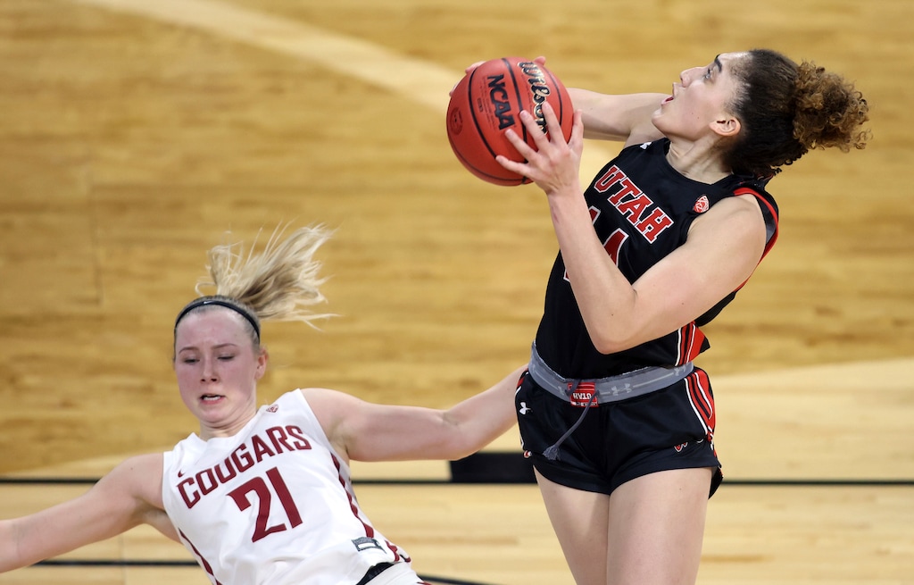 (Isaac Brekken | AP) Utah guard Niyah Becker (14) drives as Washington State guard Johanna Teder (21) falls while defending during an NCAA college basketball game in the first round of the Pac-12 women's tournament Wednesday, March 3, 2021, in Las Vegas.