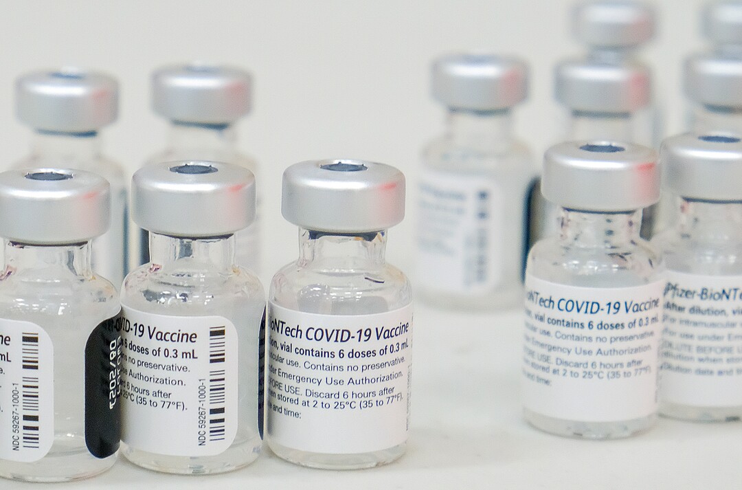 (Leah Hogsten | The Salt Lake Tribune) Empty vials of the Pfizer COVID19 vaccine at the Woods Cross High School pop-up clinic by Nomi Health,  April 27, 2021. County and regional health districts are setting up vaccination clinics in high schools, to get the COVID-19 vaccine to 16- and 17-year-olds.