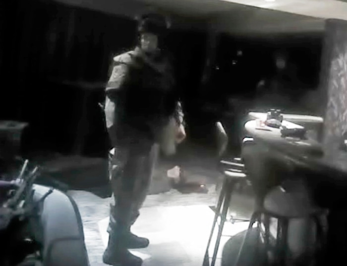 GRAPHIC CONTENT -This photo from police officer video body camera footage on Oct. 1, 2017, provided by the Las Vegas Metropolitan Police Department, shows the body of shooter Stephen Paddock on the floor behind an officer, following during the deadliest mass shooting in modern U.S. history, at the Mandalay Bay Hotel in Las Vegas, released Wednesday, May 2, 2018. (Las Vegas Metropolitan Police Department via AP)