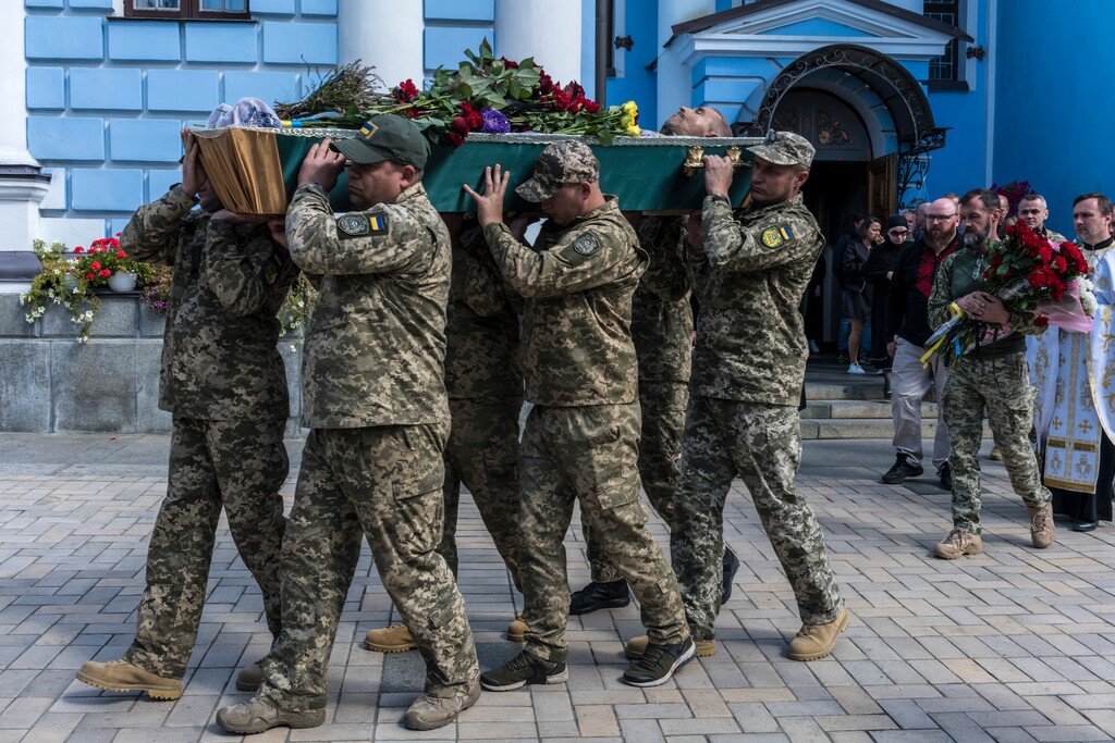 (Brendan Hoffman | The New York Times)

The body of Ukrainian soldier Vyacheslav Nalyvayko is carried out of St. Michael's Golden-Domed Monastery during a funeral in Kyiv, Ukraine on Wednesday, Sept. 7, 2022.