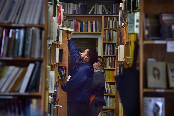 (Scott Sommerdorf | The Salt Lake Tribune)
Sarah Hollenberg and Ian Burnley looked for books on Small Business Saturday at Ken Sanders Rare Books, Saturday, November 25, 2017.