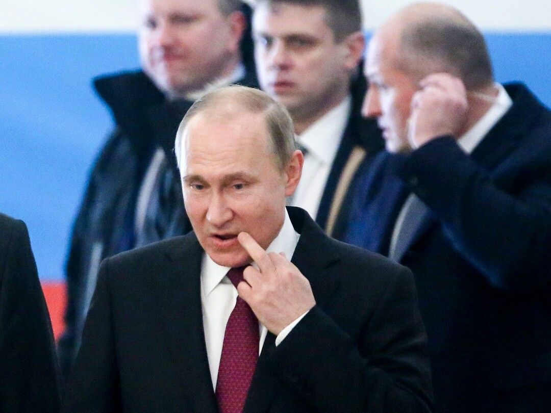 Russian President and Presidential candidate Vladimir Putin arrives to vote at a polling station during Russia's presidential election in Moscow, Russia, Sunday, March 18, 2018. Putin's victory in Russia's presidential election Sunday isn't in doubt. The only real question is whether voters will turn out in big enough numbers to hand him a convincing mandate for his fourth term — and many Russian workers are facing intense pressure to do so. (Sergei Chrikov/Pool Photo via AP)