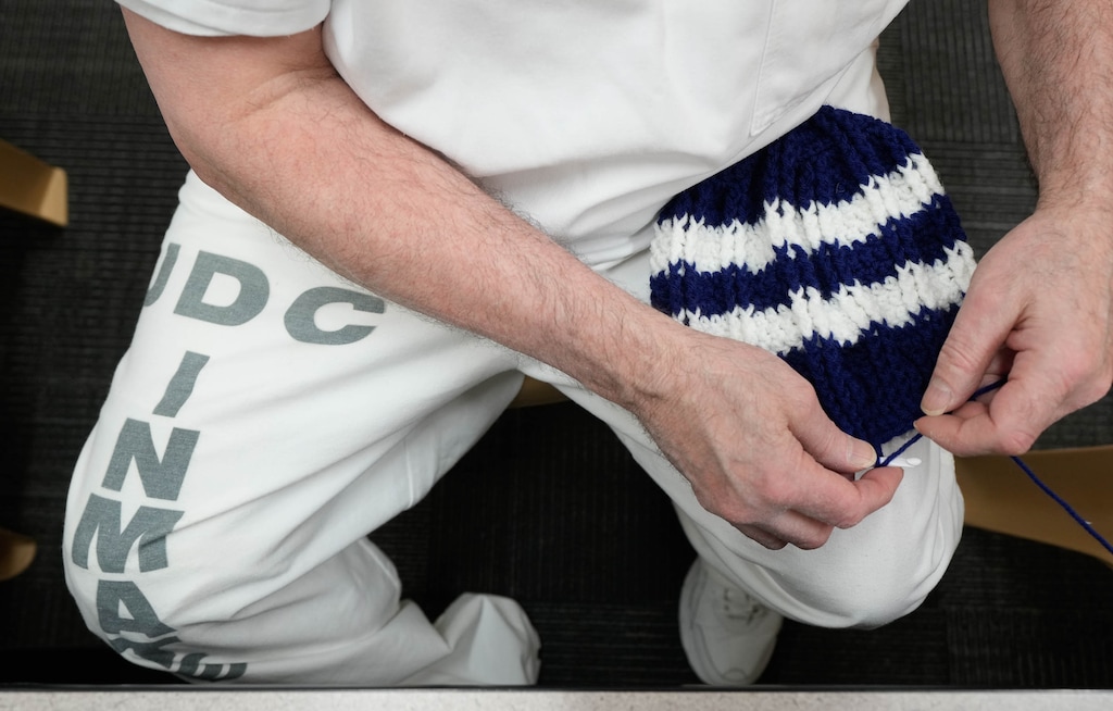 (Francisco Kjolseth | The Salt Lake Tribune) Donald Neilson prefers to do his crochet work on his leg and close to his body so he can more clearly see his progress as he nears completion on a hat at the Utah State Correctional Facility on Friday, Dec. 15, 2023. The hats are eventually donated to Utah's unsheltered community.