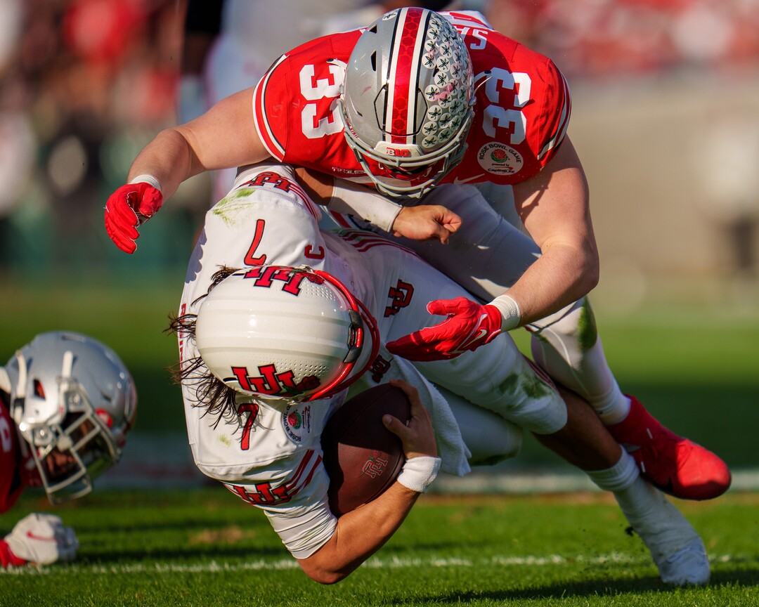 (Trent Nelson  |  The Salt Lake Tribune) Utah Utes quarterback Cameron Rising (7) is hit by Ohio State Buckeyes defensive end Jack Sawyer (33) as the Utah Utes face the Ohio State Buckeyes at the Rose Bowl in Pasadena, Calif., on Saturday, Jan. 1, 2022.