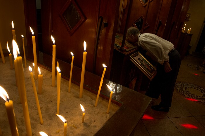 (Leah Hogsten  |  The Salt Lake Tribune) Diean Dinas kisses the Teotokos and Christ icon prior to leaving the Holy Trinity Cathedral Greek Orthodox Church during the 42nd Annual Greek Festival. The three day festival offers a wide variety of food and pastries, Greek musicians and dance performances.
