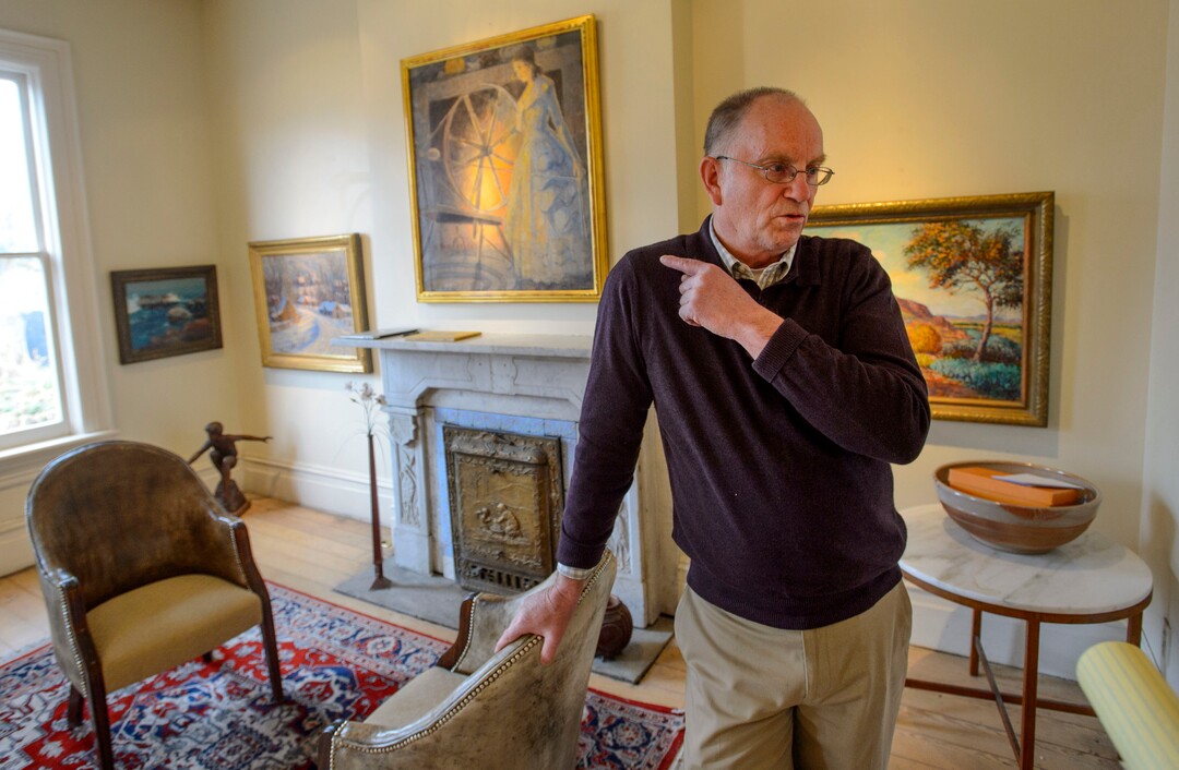 (Steve Griffin  |  The Salt Lake Tribune) Dave Ericson with four of 11 historic Utah paintings that the Logan City School District is selling in a sealed-bid auction.