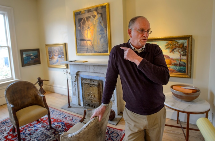 (Steve Griffin  |  The Salt Lake Tribune) Dave Ericson with four of 11 historic Utah paintings that the Logan City School District is selling in a sealed-bid auction.