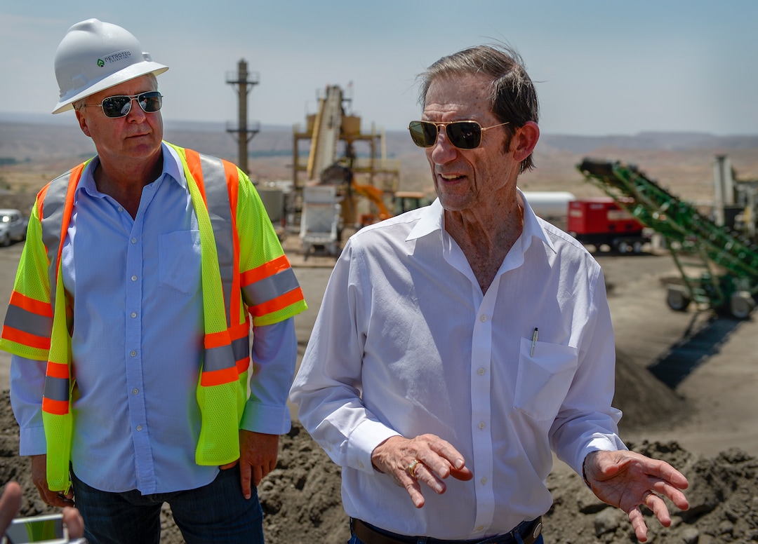 (Leah Hogsten  |  The Salt Lake Tribune)  "I call it our secret sauce," said Petroteq Energy chairman Gerald Bailey, right, of the proprietary mixture of solvents used to extract oil from sand, during a tour of the company's Uinta Basin quarry and extraction plant, Thursday, June 14, 2018. Petroteq CEO David Sealock is at left. Petroteq claims to have perfected and patented a process to extract crude oil from tar sands in a cost-effective, environmentally friendly way.  "It's simple physical separation," added Bailey, "we just wash that oil right out of the sand with our solvent.Ó