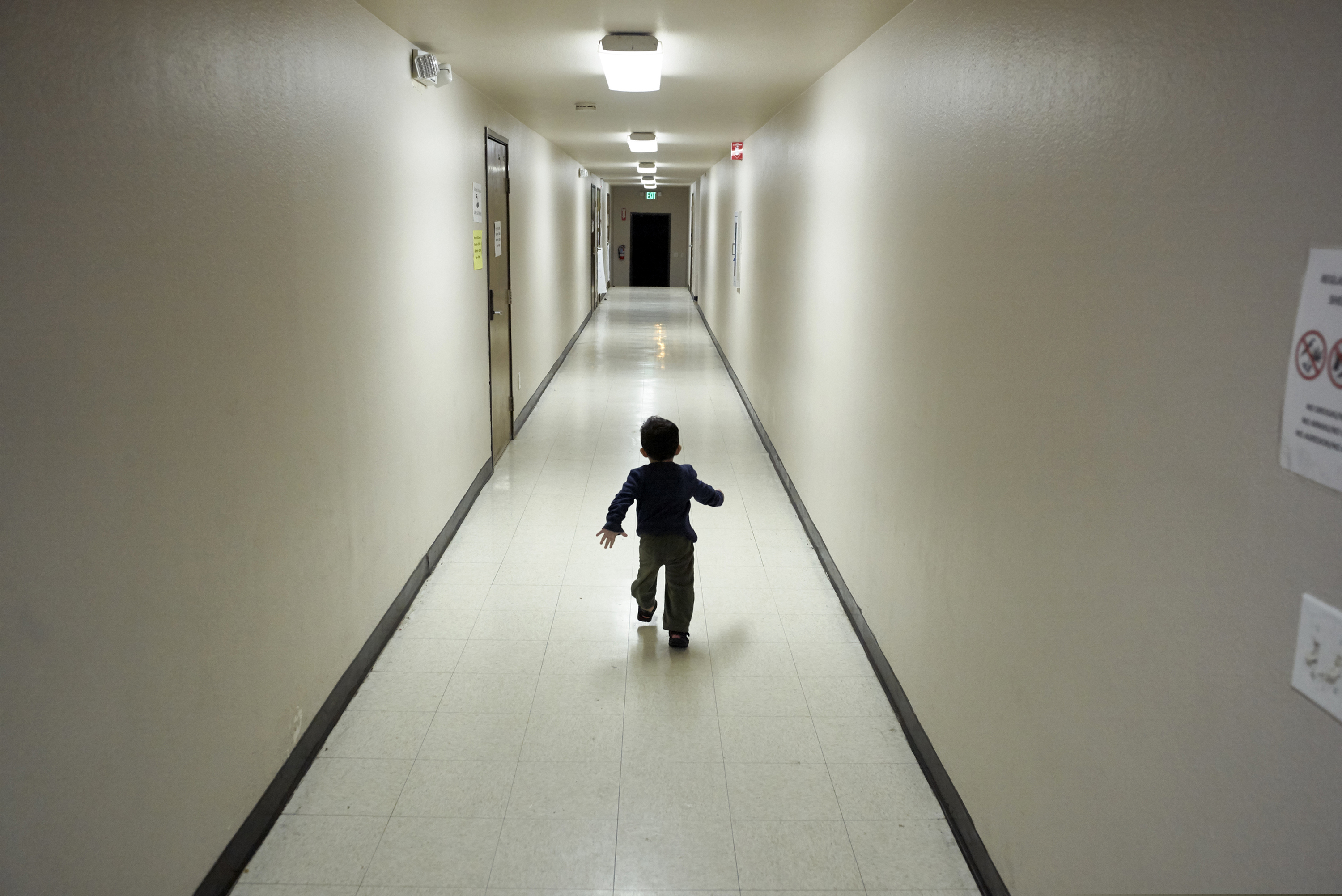 (Gregory Bull | AP File Photo) In this Dec. 11, 2018 photo, an asylum-seeking boy from Central America runs down a hallway after arriving from an immigration detention center to a shelter in San Diego. The Trump administration will make a case in court to end a longstanding settlement governing detention conditions for immigrant children, including how long they can be held by the government. A hearing is scheduled before a federal judge Friday, Sept. 27, 2019, in Los Angeles over the so-called Flores settlement.