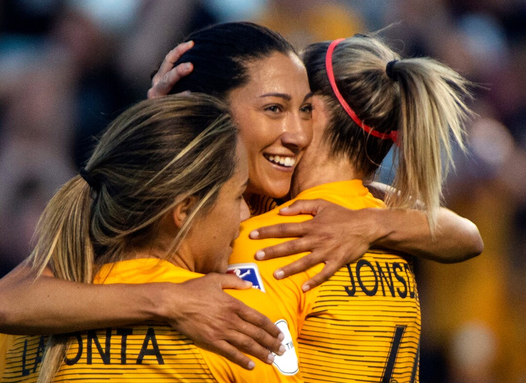 (Rick Egan  |  The Salt Lake Tribune)    Utah forward Christen Press (23) gets hugs from Utah Royals FC midfielder Lo'eau LaBonta (9) and Utah Royals FC defender Becky Sauerbrunn (16), after scoring a goal for the Royals, in Soccer action between Utah Royals FC and Portland Thorns FC, in Sandy, Friday, July 19, 2019.