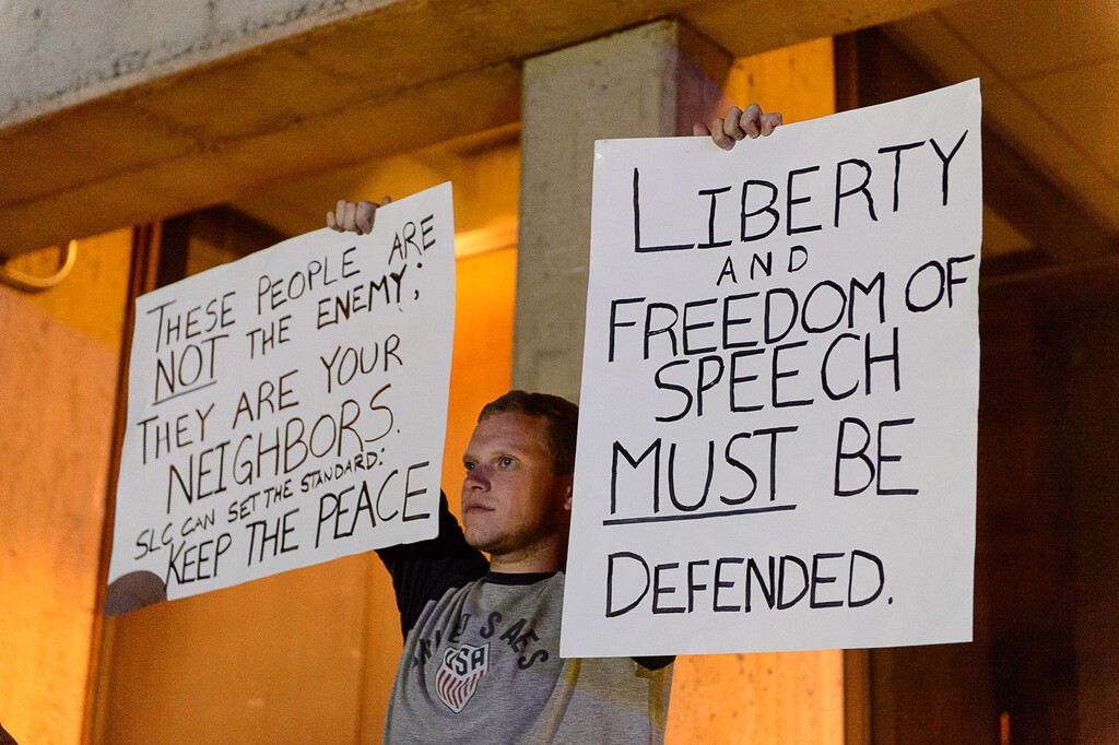 (Trent Nelson | The Salt Lake Tribune)  A man holds a sign advocating for freedom of speech toward a group of protesters rallying against an appearance by Ben Shapiro at the University of Utah in Salt Lake City, Wednesday September 27, 2017.