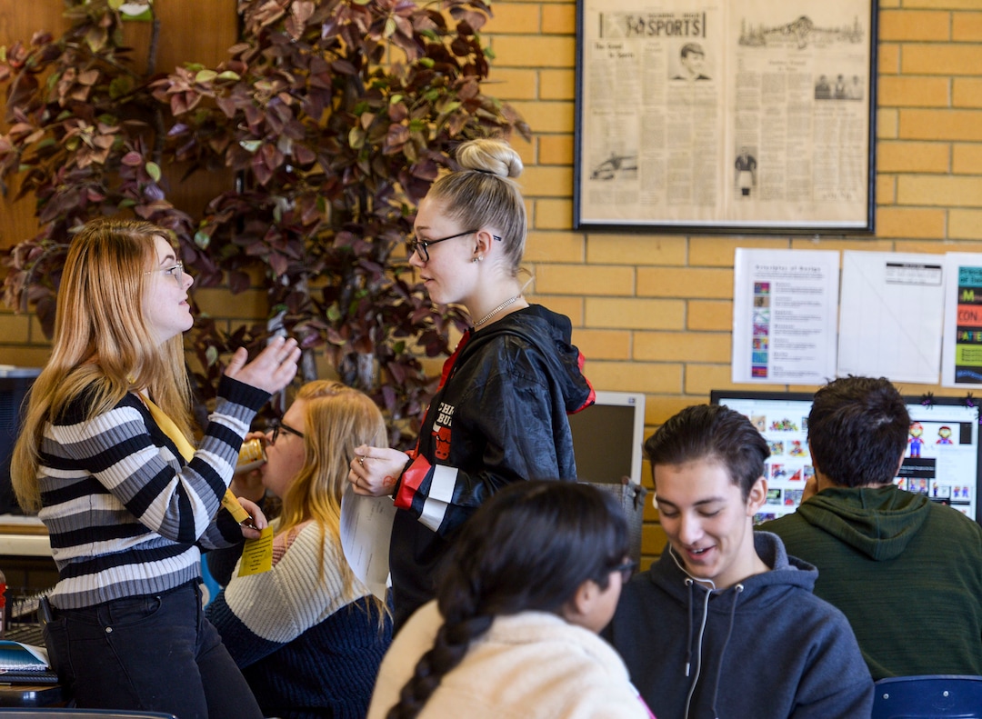 (Leah Hogsten  |  The Salt Lake Tribune) Maddy Littleford, editor-in chief, left, and Kadie Gorman, copy editor, right, discuss the next issue of The Cougar Claw Nov. 26. The student newspaper at Kearns High School is working to become the community newspaper for Kearns.