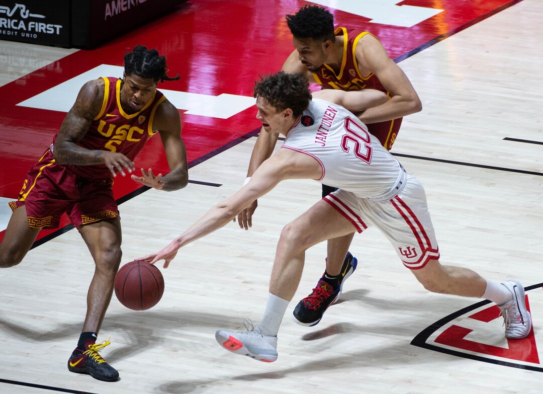 (Francisco Kjolseth  | The Salt Lake Tribune) USC Trojans guard Isaiah White (5) and USC Trojans forward Isaiah Mobley (3) battle Utah Utes forward Mikael Jantunen (20) for a loose ball in PAC-12 basketball action at the Jon M. Huntsman Center, on Saturday, Feb. 27, 2021.