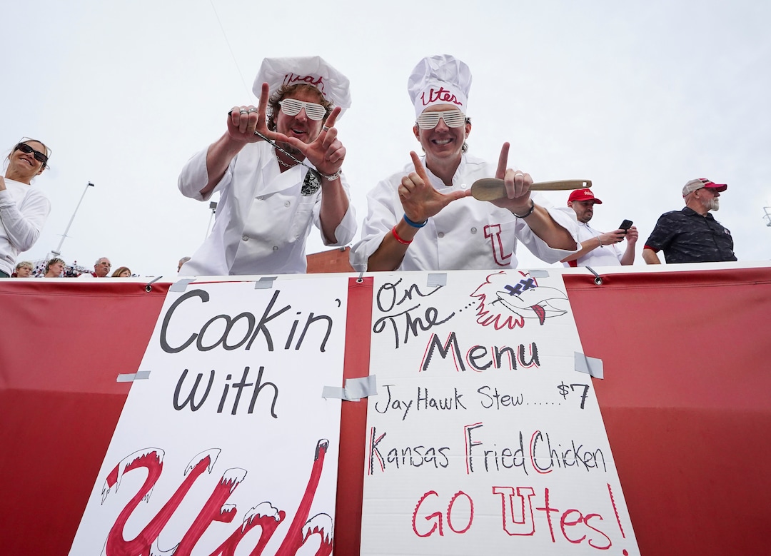 (Bethany Baker  |  The Salt Lake Tribune) Fans gesture beside their homemade signs during the game between the Utah Utes and the Kansas Jayhawks at Rice-Eccles Stadium in Salt Lake City on Tuesday, Jan. 28, 2020.