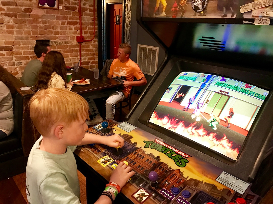 (Heather May | Special to The Tribune) Luke, 8, plays at arcade game at Lucky Slice Pizza in Ogden.