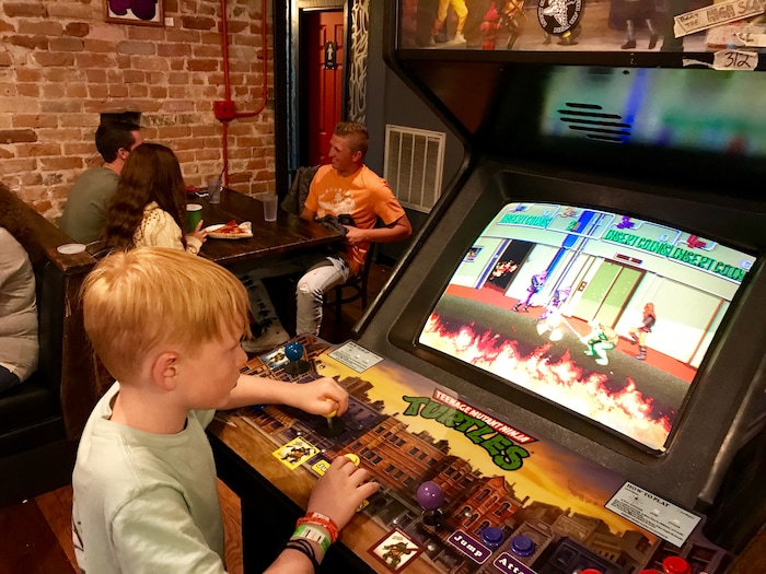 (Heather May | Special to The Tribune) Luke, 8, plays at arcade game at Lucky Slice Pizza in Ogden.