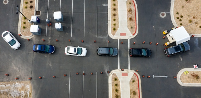 (Leah Hogsten  |  The Salt Lake Tribune) A line of cars bends around the University Of Utah Hospital's parking lot as people wait for COVID-19 testing in Farmington, Oct. 23, 2020.