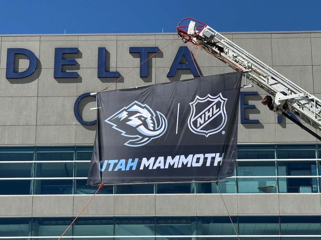 (Trent Nelson | The Salt Lake Tribune) A Utah Mammoth banner is raised outside Delta Center in Salt Lake City on May 7, 2025. Smith Entertainment Group has announced that the Mammoth will be the new name for the former Utah Hockey Club.