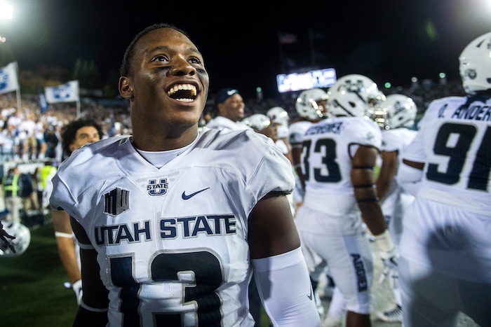 (Chris Detrick  |  The Salt Lake Tribune)  Utah State Aggies cornerback Jalen Davis (13) celebrates after the game at Merlin Olsen Field at Maverik Stadium Friday, September 29, 2017. Utah State Aggies defeated Brigham Young Cougars 40-24.