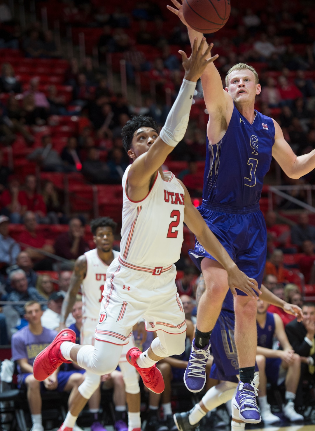 (Rick Egan  |  The Salt Lake Tribune)       College of Idaho guard Jake Bruner blocks a shot by Utah Utes guard Sedrick Barefield (2), in basketball action, between the Utah Utes and the College of Idaho Yotes at the Jon M. Huntsman Center, Thursday, Nov. 1, 2018.