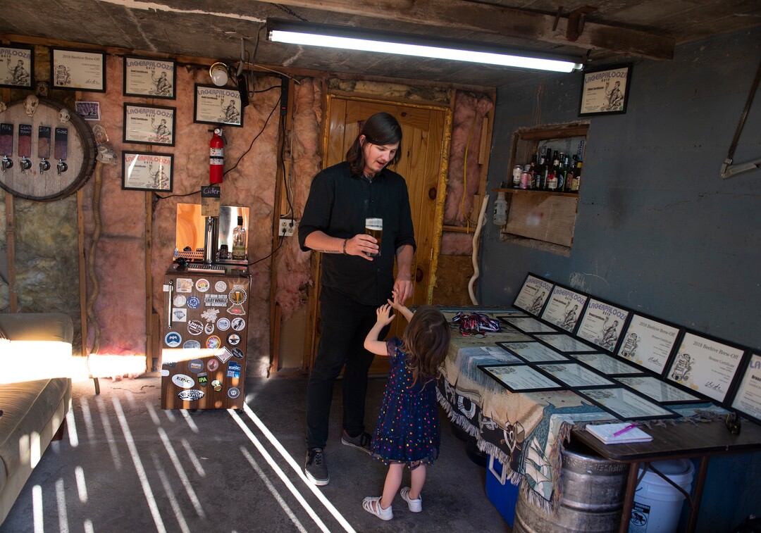 (Leah Hogsten  |  The Salt Lake Tribune)   Landon Jeffery talks to his daughter Vivenne, 4, in the basement where Jeffery brews five gallons of beer once a week. Jeffery was named Utah's "Best Home Brewer" during the 2019 Beehive Brewoff. Jeffery earned five gold medals, three silver and a bronze, including the "best beer." In 2019, Jeffery won 18 medals between Lagerpalooza, a homebrewing contest just for lagers and the Beehive Brewoff.